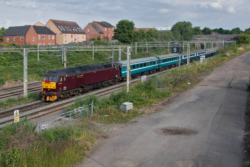 47813, outward leg of 'The Well-Dressed Queen and the Buxton Bush', 06.48 London Euston-Buxton (1Z86, 26L), site of Roade station 
 Swinging along at the rear going for a ride to Buxton 47813 contrasts in its WCR livery to the former Greater Anglia liveried Mk. II stock. The charter was named The Well-Dressed Queen and the Buxton Bush and I would welcome anybody to inform me what it was all about please as I have no idea? Running as 1Z86, the usual reporting number for The Cumbrian Mountain/Coast Express charters, this one left Euston at 06.48 with pickups all the way as far as Manchester ending up at Buxton. 
 Keywords: 47813 The Well-Dressed Queen and the Buxton Bush 06.48 London Euston-Buxton 1Z86 site of Roade station WCR West Coast Railway