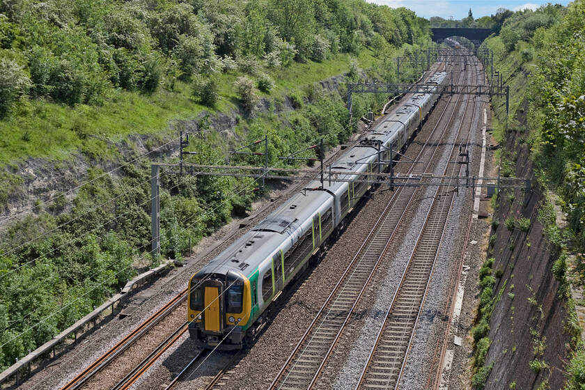 350123, LM 11.25 London Euston-Crewe (2Y18), Roade cutting 
 The 11.25 Euston to Crewe London Midland train passes through Roade cutting on the down slow line. On weekdays this train would not take the Northampton line but use the down fast line via Weedon but not at weekends. 350123 and another unit behind will stop at both Northampton and Long Buckby adding to their journey time. 
 Keywords: 350123 11.25 London Euston-Crewe 2Y18 Roade cutting London Midland Trains Desiro