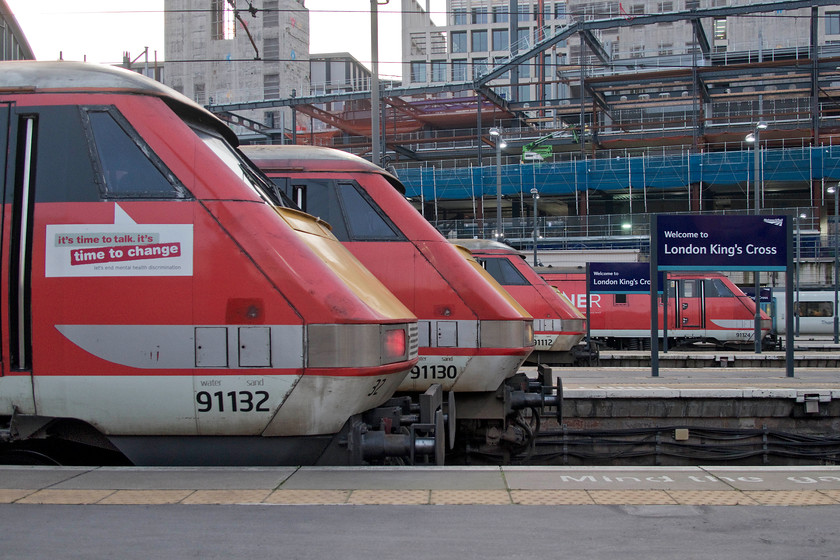 91132, 91130, 91112 & 91124, unidentified services, London King`s Cross station 
 A line up of four class 91s at King's Cross with no Azuma in sight! In the foreground is 91132 that is numbered out of sequence being originally numbered 91023. However, after being involved on both the Great Heck and Hatfield disasters it was given its present-day number rather than 91123 that it ought to have carried. Beyond is 91130 'Lord Mayor of Newcastle', then 91112 and 91124. 
 Keywords: 91132 91130 91112 91124 London King`s Cross station LNER Lord Mayor of Newcastle