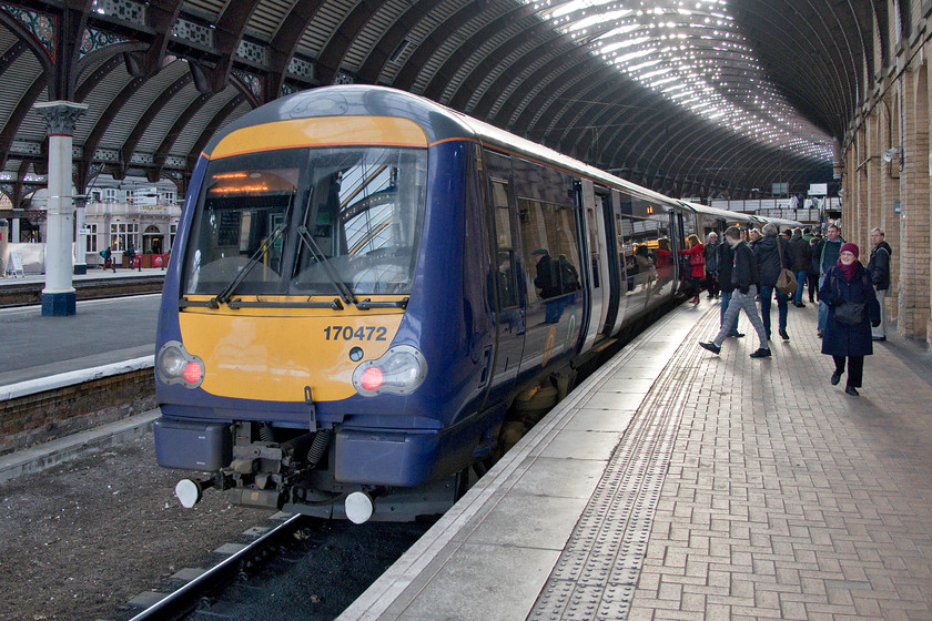 170472, NT 11.11 York-Leeds (2C33, 11L), York station 
 Passengers board 170472 at York station. The ex ScotRail unit was going to work the 11.11 to Leeds via Harrogate that Mike and I took as far as Knaresborough. We both commented on the smart and comfortable interior of the 'refreshed' three-car DMU. The seats were roomy and comfortable and the train rode well. However, the old problem of vibration and noise from the under-frame mounted engines on the class 172s was still everpresent! 
 Keywords: 170472 11.11 York-Leeds 2C33 York station