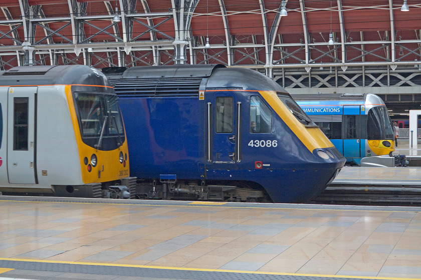 360202, HC 14.03 London Paddington-HeathrowT5 (2T46, RT), 43086 14.30 GW London Paddington-Swansea (1B46, 15L) & 332009 HX London Paddington-Heathrow T5 (1T61, 6L), London Paddington station 
 Three units on the stops at Paddington operated by three different TOCs. Heathrow Connect's 360202 waits to leave with the 14.03 to Heathrow Terminal 5. Next to it is FGW's 43086 that will work the 4.30 to Weston-Super-Mare. Finally, at the back is Heathrow Express' 1T61 also going to Heathrow Terminal 5. 
 Keywords: 360202 2T46 43086 1B46 332009 1T61 London Paddington station