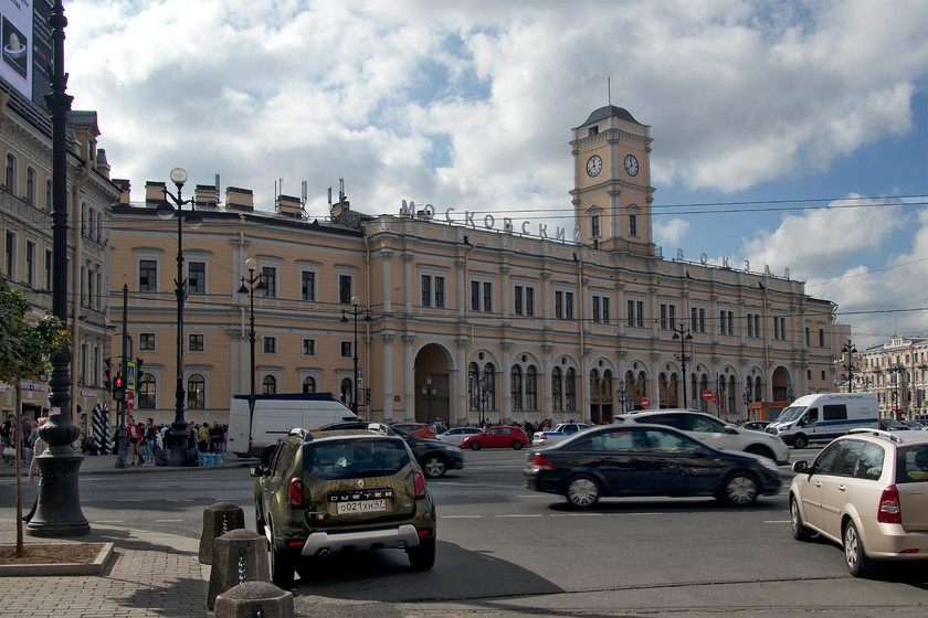 Frontage, St. Petersburg Moskovski station 
 The station on this site opened in 1851. This building was completed by 1855 and is the twin of Moscow's Leningradsky station with many trains both classic and Sapsan high-speed variants running between the two day and night. RZD (Russian railways) say that Moskovsky station is the third busiest in Russia and if the frantic nature of the roads and car park in front of the station, as seen in this scene was anything to go by I believe them! 
 Keywords: St. Petersburg Moskovsky station