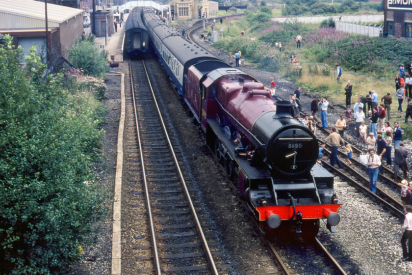 5690, BR sponsored Manchester-Liverpool Edge Hill Special, photostop, Earlestown station 
 5690 'Leander' pauses at Earlstown station for a photo stop in the days when passengers were permitted to alight from the train and wander about with impunity to take their photographs or get a 'cab' of the locomotive. Leander was leading the outward leg of a BR sponsored special from Manchester to Liverpool Edge Hill and back again as part of the Rocket 150 celebrations. In this view taken from Junction Lane bridge the track curving sharply away to the south leads to Winwick Junction where it joins the WCML a short distance away. 
 Keywords: 5690, BR sponsored Manchester-Liverpool Edge Hill Special, photo stop, Earlestown station