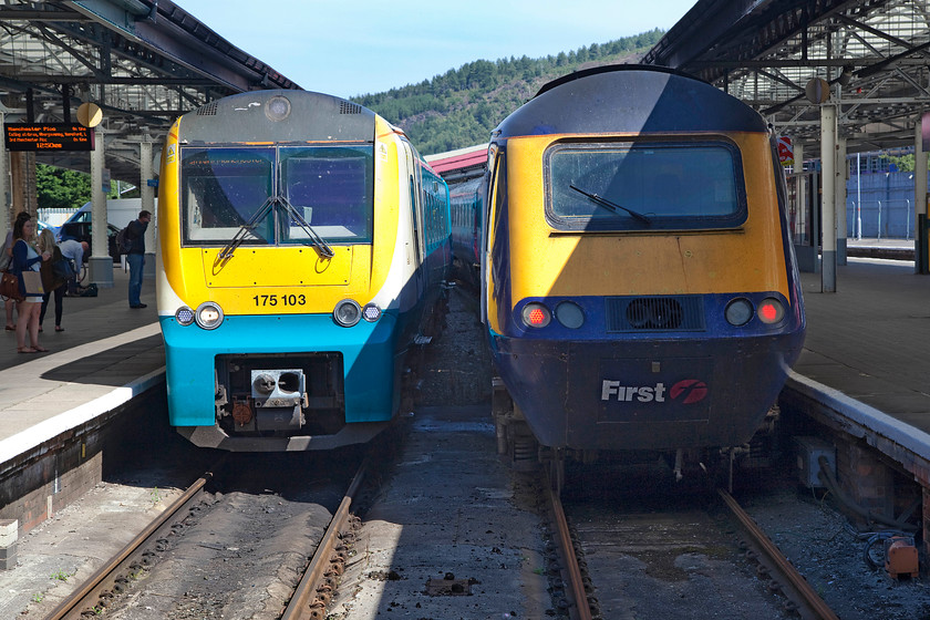 175103, AW 11.10 Milford Haven-Manchester Piccadilly (1W16) & 43139, GW 13.28 Swansea-London Paddington (1L66), Swansea station 
 Side by side at Swansea! To the left, ATW's 11.10 Milford Haven to Manchester Piccadilly waits to leave formed by 165103. It has arrived at the Welsh terminus and will then reverse o continue its journey. To the right, 43139 'Driver Stan Martin 25 June 1950-6 November 2004' will work the 13.28 to Paddington. Despite my many years of interest in all things railway, this was my first visit to Swansea station, quite how this situation has arisen, I am not sure? 
 Keywords: 175103 11.10 Milford Haven-Manchester Piccadilly 1W16 43139 13.28 Swansea-London Paddington 1L66 Swansea station