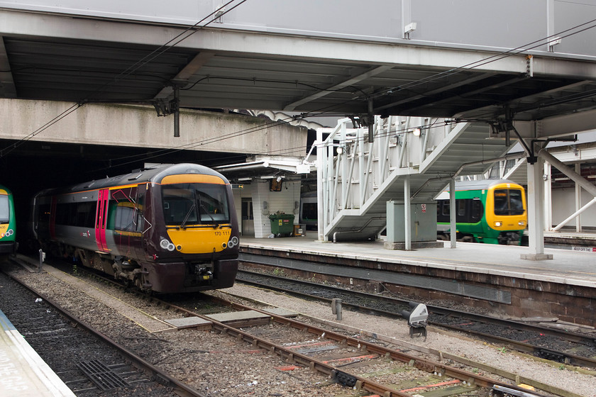 170630, LM 12.49 Birmingham New Street-Hereford (1V27, 2L), 170111, stabled & class 323, LM 11.46 Four Oaks-Longbridge (2N38), Birmingham New Street station 
 Cross Country 170111 stands stabled in the middle road at Birmingham New Street station. An unidentified class 323 is just leaving working the 2N38 11.46 Four Oaks to Longbridge. Despite the 'improvements' to the station, I still find the platform level at New Street oppressive and dark. 
 Keywords: 170630 1V27 170111, stabled class 323 2N38 Birmingham New Street station