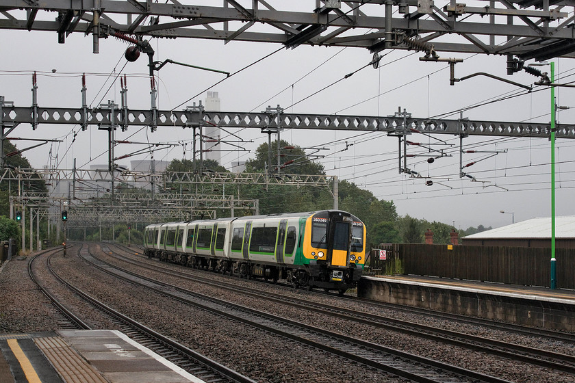 350249, LN 14.46 London Euston-Crewe (1U39, RT), Rugeley Trent Valley station 
 The rain has all but stopped now, for the first time all day! With the bulk of the closed Rugeley power station seen through the murk in the background, 350249 takes the steeply cambered track into Trent Valley station with the 14.46 Euston to Crewe service. After following the Chase Line for the last hours or so with its winding double track, the vast expanse of the Trent valley WCML route seemed absolutely huge by comparison! 
 Keywords: 350249 14.46 London Euston-Crewe 1U39 Rugeley Trent Valley station