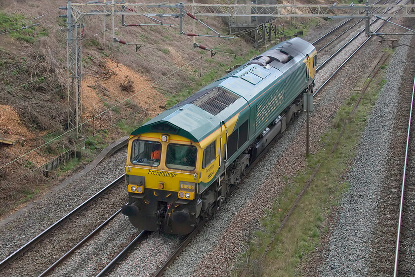 66504, 11.13 Felixstowe North-Trafford Park (0M27, 2L), Victoria bridge 
 I do not know quite what went on here but something went awry with the 4M87 Felixstowe to Trafford Park Freightliner service today! On OpenTrainTimes I could quite clearly see this mysterious 0M27 heading northwards but with nothing on either RTT or the Live Train Times site, I was mystified to see what would appear in the distance. Looking a little worse for wear 66504 rumbles past Victoria bridge near Roade running in the 4M87 slot but as a light engine move from Wembley Yard to Crewe Basford Hall. This information appeared later on RTT after it had arrived at its new destination. 
 Keywords: 66504 11.13 Felixstowe North-Trafford Park 0M27 Victoria bridge Freightliner