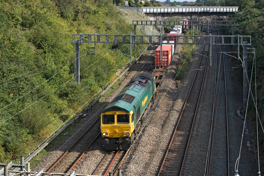 66569, 11.13 Felixstowe North-Ditton (4M87, 7L), Hyde Road bridge 
 66569, recently and somewhat oddly named 'Gerald 'The Rule Book' Riley' passes through Roade leading the 11.13 Felixstowe to Ditton Freightliner. The 66 was named in July in a small ceremony at Ipswich station held to celebrate more than fifty-five years of service of the Rail Safety and Standards Board staff member Gerald Riley. 
 Keywords: 66569 11.13 Felixstowe North-Ditton 4M87 Hyde Road bridge Gerald 'The Rule Book' Riley.