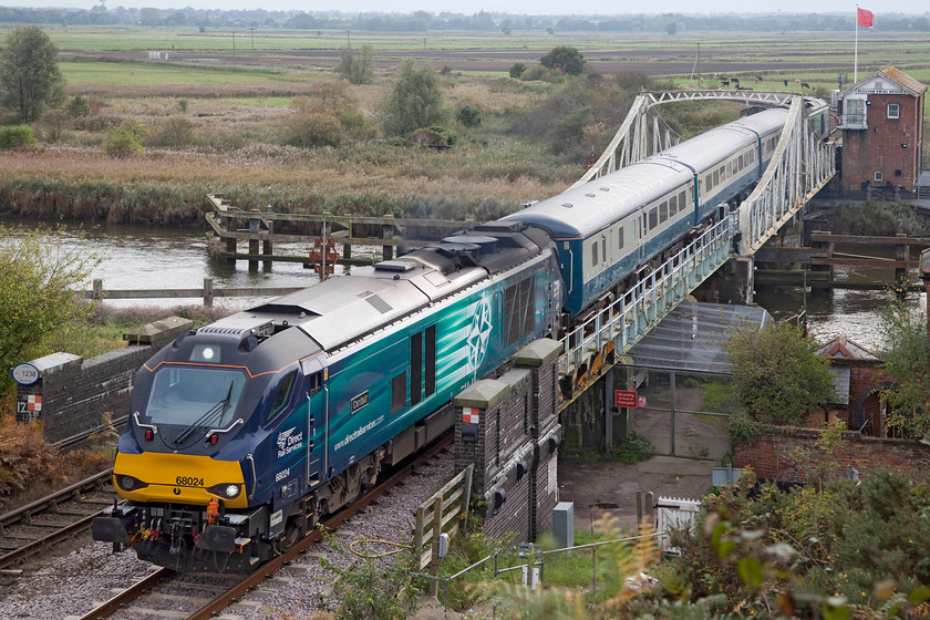 68024 & 68004, LE 12.57 Lowestoft-Norwich (2J77), Reedham swing-bridge 
 68024 'Centaur' rattles its way over Reedham's superb swing-bridge leading the 12.57 Lowestoft to Norwich. Just passing Reedham Swing Bridge signal box, at the rear of the train, is 68004 'Rapid'. In a short distance, the train will pass over Reedham Junction where the line is joined by the one from Great Yarmouth via Berney Arms. 
 Keywords: 68024 68004 12.57 Lowestoft-Norwich 2J77 Reedham swing-bridge