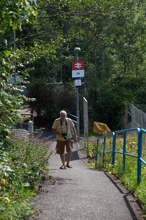 Andy, IBM station 
 Andy walks up the path away from IBM station as we return the short distance to a relatively new but now un-used industrial unit. The whole area was all very weird and slightly eerie with wildlife gradually beginning to take over. Modern urban decay is very strange and sets the hairs on the back of my neck on end, and this area, desperately being marketed as Valleypark, was certainly a strange place! 
 Keywords: IBM station