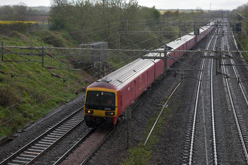 325001, an unidentified 325 & 325002, 16.22 Wembley-Sheildmuir (1S96), Victoria Bridge 
 Now it's really pouring and the light has all but disappeared! Three class 325s led by 325001 pass Victoria Bridge near Roade working the 1S96 16.22 Wembley to Sheildmuir postal train. This is one of several 'postals' that run up and down the WCML during the day. Not all mail has been lost from the railways as people would have you think! 
 Keywords: 325001 325002 16.22 Wembley-Sheildmuir 1S96 Victoria Bridge