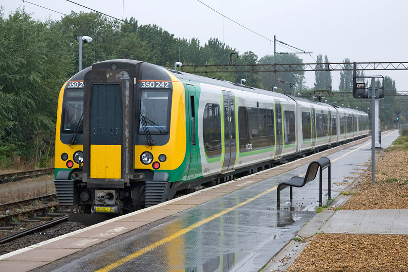 350242, LM 07.49 London Euston-Birmingham New Street (1W03), Northampton station 
 350242 leaves Northampton's platform three adjacent to the Riverside sidings working the 07.49 Euston to Birmingham New Street. After such a smashing day yesterday, see..... https://www.ontheupfast.com/p/21936chg/C368486604/x54-roade-cutting-13-09-15 today could not be more different such are the vagaries of the British weather! 
 Keywords: 350242 07.49 London Euston-Birmingham New Street 1W03 Northampton station London Midland Desiro