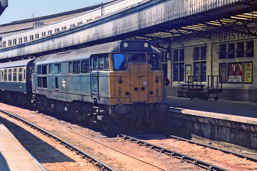 31254, unidentified Portsmouth-Harbour working, Bristol Temple Meads station 
 31254 stands under one of Bristol Temple Meads' canopies sheltering from the hot July sun. 31254 was Bath Road locomotive for many years, but by the time that this picture was taken, it only had a limited life. It was an early casualty being withdrawn in December 1979 and cut up at Old Oak Common.