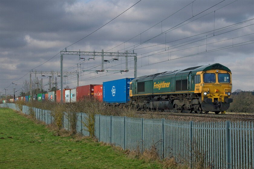 66543, 05.00 Trafford Park-Felixstowe North (4L75, 207E), Wilson's Crossing 
 Just catching a little brightness on what was a bone-chillingly cold day 66543 approaches Northampton at Wilson's Crossing leading the 4L75 05.00 Trafford Park to Felixstowe Freightliner. Interestingly, the last time that I photographed this locomotive was at the same location but looking in the other direction on the balancing working; what are the chances of that I wonder? See..... https://www.ontheupfast.com/p/21936chg/29621848404/x66543-09-12-felixstowe-north-trafford 
 Keywords: 66543 05.00 Trafford Park-Felixstowe North 4L75 Wilson's Crossing Freightliner