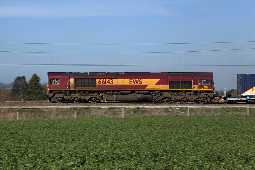 66143, Hams Hall-Dollands Moor (4Z57 VSTP pathed), Milton Malsor SP740558 
 EWS liveried 66143 passes Milton Malsor just south of Northampton leading a Hms Hall to Dollands Moor Freightliner service. This is not a regular working an was pathed under VSTP (Very Short Term Planning) as do a number of services heading to Dollands Moor and the continent. If anybody can pass on to me any further information about this service please get in contact through the website. 
 Keywords: 66143 Hams Hall-Dollands Moor 4Z57 VSTP Milton Malsor SP740558