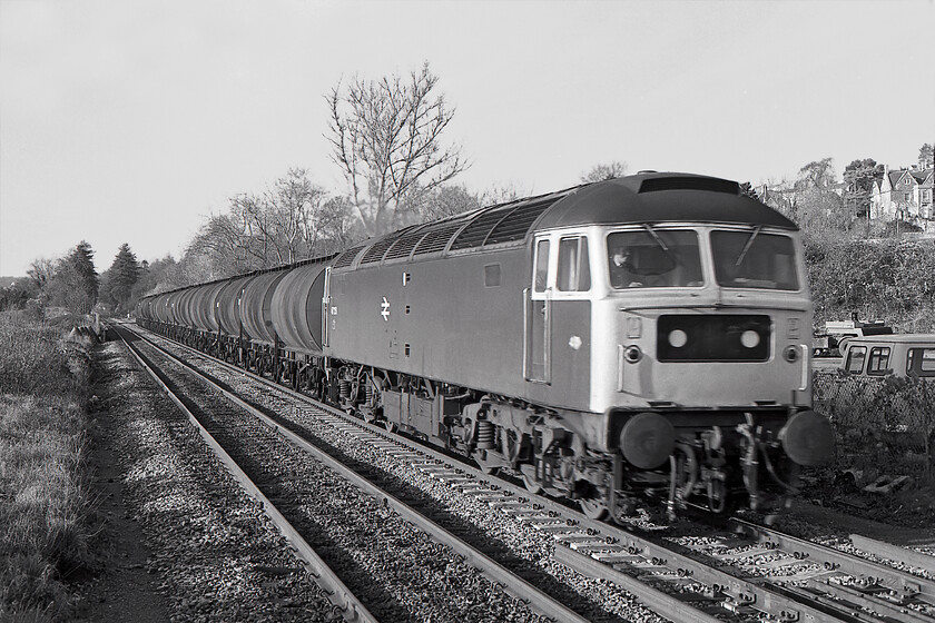 47251, up oil tankers, Bradford-on-Avon station 
 Up until 1990 47251 was a locally based member of the class moving regularly between Cardiff Canton and Bristol Bath Road depots meaning that I will have spotted it often while living near to Bradford-on-Avon. It is seen, unfortunately suffering from a little motion blur, leading an oil tanker train through Bradford-on-Avon in some lovely early winter light. Happily, 47251 is still with us as one of DRS' Thunderbirds now numbered 57302 'Chad Varah'. Previous to this it was one of Virgin's machines named 'Virgil Tracy'. 
 Keywords: 47251 up oil tankers Bradford-on-Avon station