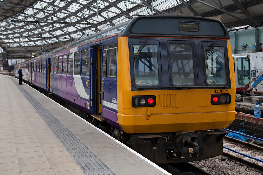 142004 & 156471, NT 12.27 Liverpool Lime Street-Manchester Oxford Road (2O91, 3L), Liverpool Lime Street Station 
 A 'Pacer and Super Sprinter' combo at Liverpool Lime Street. 142004 and 156471 wait at platform 9 ready to work the 12.27 to Manchester Oxford Road. If I was travelling on this working, what unit would I choose to ride in, the 142 or the 156....your thoughts? 
 Keywords: 142004 156471 2O91 Liverpool Lime Street Station