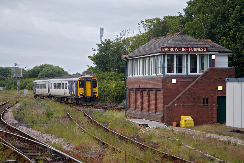 156471, NT 17.07 Carlisle-Barrow-in-Furness (2C40, 4E), Barrow-in-Furness station 
 156471 approaches its destination working the 2C40 17.07 ex Carlisle. It is about to pass the rear of the fine 1907 Furness signal box. Very little has changed since I took an almost identical photograph in 2019 but for the growth of weeds on the trackbeds, see... https://www.ontheupfast.com/p/21936chg/24425914804/x156443-2c51-barrow-furness-signal Ironically, when I visited the box in 1984 I photographed the ICI weedkilling train passing this spot hauled by a Class 25. The picture of this event will be scanned and uploaded when time permits! 
 Keywords: 156471 17.07 Carlisle-Barrow-in-Furness 2C40 Barrow-in-Furness station Northern