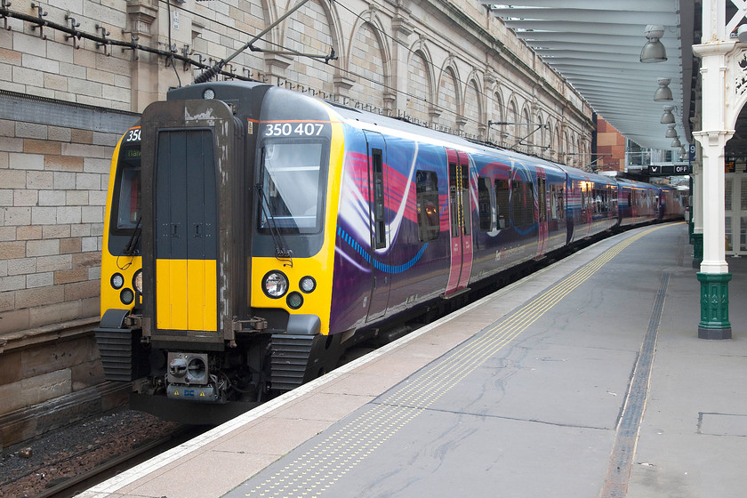 350407, TP 10.12 Edinburgh Waverley-Manchester Airport (1M95), Edinburgh Waverley station 
 In its rather garish TPE livery, 350407 waits to leave Edinburgh Waverley working the 10.12 to Manchester Airport. I hope that any passengers travelling to the Airport on this day did not miss their flights as the train was cancelled from Piccadilly. 
 Keywords: 350407 10.12 Edinburgh Waverley-Manchester Airport 1M95 Edinburgh Waverley station