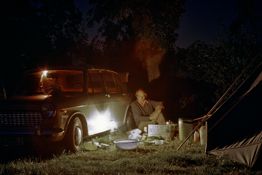 Graham, camp site Kelsterton SJ275704 
 Having cooked some supper Graham relaxes leaning against his Austin 1100 (UVJ 129J) painted in a delightful shade of beige that British Leyland optimistically referred to as Bedouin with an Autumn Leaf vinyl interior that you and I would describe as brown! We have set up camp for the night in a field just outside Connah's Quay near the village of Chesterton. Having had a cracking day on the Welsh Marches we were now looking forward to the delights of the North Wales coast! 
 Keywords: Graham camp site Kelsterton SJ275704