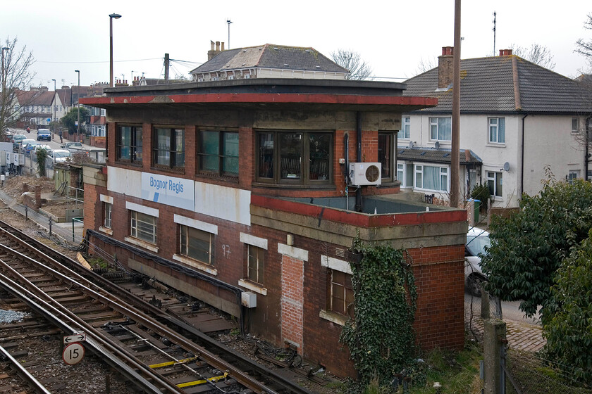 Bognor Regis signal box (SR, 1938) 
 Still wearing its huge Network SouthEast nameboard Bognor Regis signal box is seen located at the northern end of the station throat. The iconic Type 13 boxes were built by the Southern between 1936 and 1946 in an effort to promote their go-ahead approach approach and were associated with its main line electrification schemes. This example was built in 1938 to the classic design complete with curves to both the brickwork and the glass giving them their 'Odeon' nickname. This box contains a sixty-six lever frame and there is no date for its replacement by Network Rail; for the time being that is! 
 Keywords: Bognor Regis signal box SR, 1938 Southern