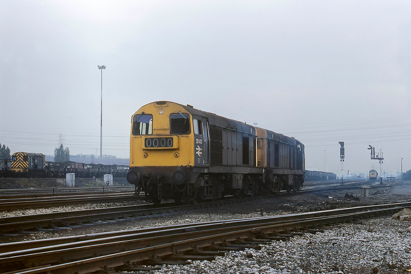 20143 & 20141, LEs, Toton Yard 
 Back at the entrance to Toton depot, 20141 and 20143 arrive light engine from the south. After a brief pause, they reversed along the line in the immediate foreground in order to get access into the depot. They went straight to the fuelling point. It cannot be seen clearly from the picture, but these two 20s were still in their BR green livery. In the background 08292 goes about its business whilst 37123 has just arrived in the yard with 37134. 
 Keywords: 20143 20141, LEs, Toton Yard