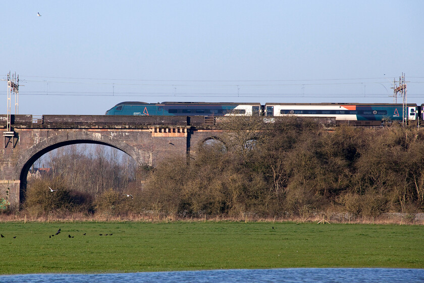 390130, VT 07.12 London Euston-Birmingham New Street (9G05, 1L), Haversham SP818425 
 390130 passes Haversham just north of Wolverton working the 07.12 Euston to Birmingham New Street service. With the field partially flooded following a day of heavy rain last week the resident mare who normally has the whole field to himself was corralled in a fenced off strip next to where I was standing to take this photograph and was taking a particular interest in what I was doing! 
 Keywords: 390130 07.12 London Euston-Birmingham New Street 9G05 Haversham SP818425 Avanti West Coast Pendolino