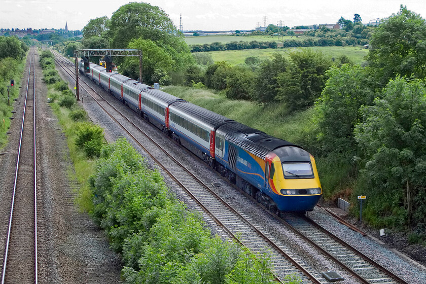 43081, EM 13.15 London St. Pancras-Nottingham (1D37), Glendon Road bridge SP855815 
 HST power car 43081 leads the 13.5 St. Pancras to Nottingham service towards Glendon Junction a short distance north of Kettering that can be seen in the background. The course of the former fourth track can be seen in the ballast that is soon to be reinstated as part of the electrification programme changing this view forever. 
 Keywords: 43081 13.15 London St. Pancras-Nottingham 1D37 Glendon Road bridge SP855815 East Midlands HST