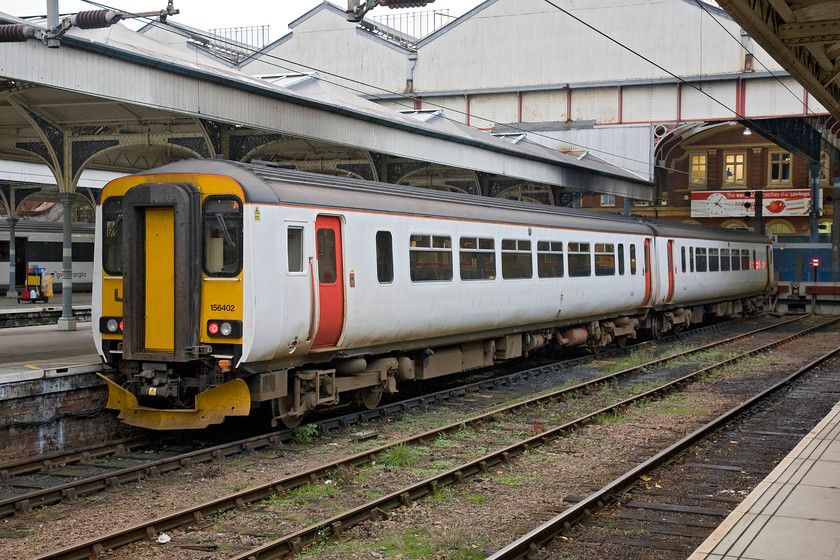 156402, LE 16.40 Norwich-Great Yarmouth (2P28), Norwich station 
 Having arrived at Norwich a short while earlier from Great Yarmouth 156402 now waits with its engines switched off and will soon work the 16.40 return working. Despite being in GA's plain livery it carries no branding that seems a little unusual? 
 Keywords: 156402 16.40 Norwich-Great Yarmouth 2P28 Norwich station GA Greater Anglia