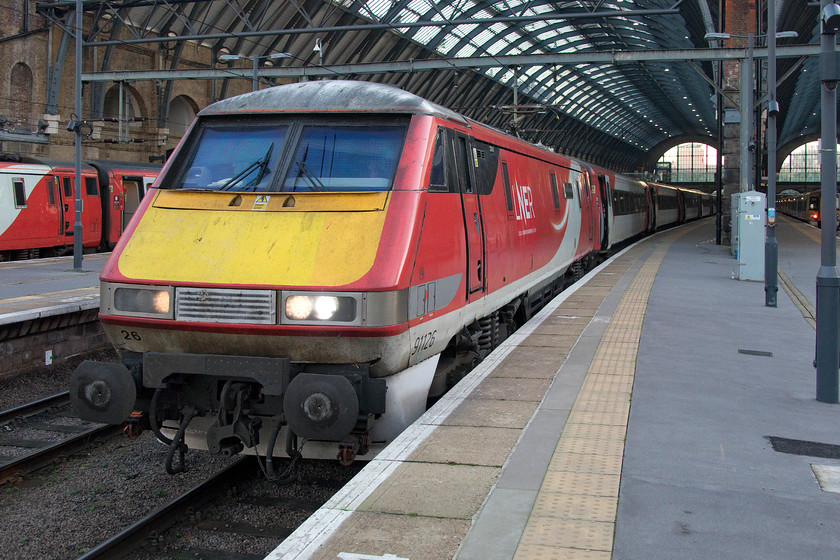 91126, GR 15.30 London King`s Cross-Edinburgh (1S23, 7L), London King`s Cross station 
 On arrival at King's Cross, I was greeted by many class 91s and sets of Mk. IV stock however, this was my first visit to King's Cross since 1977 with no HSTs present, very strange! 91126 'Darlington Hippodrome' waits at the head of the 1S23 15.30 to Edinburgh Waverley. It looks like 91116 has been in receipt of a new lower spoiler given how clean it appears to be. I wonder if it was a stock item from the stores or if it was donated by one of the 91s now withdrawn and being stripped for parts? 
 Keywords: 91126 15.30 London King`s Cross-Edinburgh 1S23 London King`s Cross station Darlington Hippodrome LNER