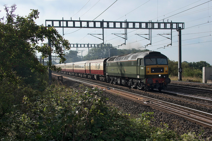 D1944, outward leg of The Palatine, 07.20 London Euston-Crewe (1Z55), Ashton Road bridge 
 For the motive power and stock concerned, this was a virtual repeat of last weeks Royal Windsor Statesman railtour that I photographed. However, who could resist the lure of some Sulzer action on the WCML again; I wonder if I would have said that forty years ago? Catching the early morning sun on its side, D1944 'Craftsman' leads the outward leg of The Palatine that left Euston at 07.20 heading for Crewe. Then steam would take over with the train taking in a circuitous route of Lancashire and Yorkshire. 47614 is out of sight on the rear of the train that is seen approaching Roade on the southern WCML near Northampton. 
 Keywords: D1944 The Palatine 07.20 London Euston-Crewe 1Z55 Ashton Road bridge