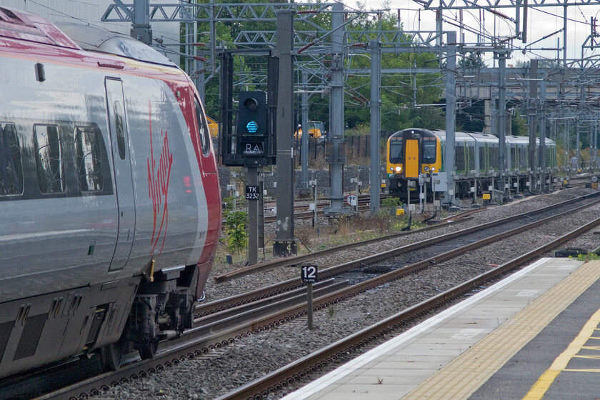 390117, VT 09.15 Manchester Piccadilly-London Euston (1A19) & 350120, LM 09.54 London Euston-Northampton (2N33), Milton Keynes station 
 Whilst 390117 'Virgin Prince' waits to head south at Milton Keynes working Virgin's 09.15 Manchester to London train 350120 arrives with the 09.54 Euston to Northampton London Midland service. Milton Keynes is a busy station with Sothern services and a lot of freight along with the services from the two operators represented here. 
 Keywords: 390117 09.15 Manchester Piccadilly-London Euston 1A19 350120 09.54 London Euston-Northampton 2N33 Milton Keynes station Virgin Trains Pendolino Virgin Prince