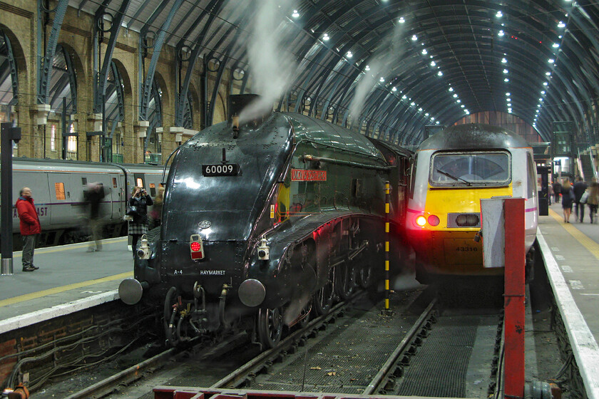 60009, return leg of The Lindum Fayre, 19.10 Lincoln-London King's Cross (1Z47) & 43316, GR 22.00 London King's Cross-Leeds (1D34), London KIng's Cross station 
 60009 'Union of South Africa' makes for a fine sight just after arriving at King's Cross with the returning Lindum Fayre charter that not unsurprisingly originated from Lincoln! Despite arriving some five minutes early no time has been wasted affixing the tail light to the front of the A4 for its final run of the day back to Southall via a reversal at Ferme Park. Evidently, all went well with this charter with passengers having a few hours in Lincoln to explore its narrow and steep streets complete with its very popular Christmas market. Next to the charter HST power car 43316 will bring up the rear of the 22.00 East Coast service to Leeds. 
 Keywords: 60009 The Lindum Fayre, 19.10 Lincoln-London King's Cross 1Z47 43316 22.00 London King's Cross-Leeds 1D34 London KIng's Cross station