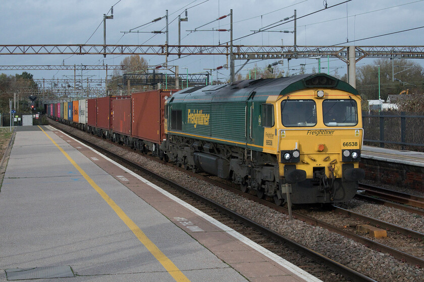 66538, 12.16 Lawley Street-London Gateway (4L46, RT), Northampton station 
 What a difference five minutes make! A short time after the preceding 4L48 had headed south under grey skies the sun has now come out and puts a different perspective on 66538 leading the 12.16 Lawley Street to London Gateway Freightliner. Also like the previous freight, this one passed straight through Northampton station without being held waiting for the movement of a London Northwestern service as is normally the case. 
 Keywords: 66538 12.16 Lawley Street-London Gateway 4L46 Northampton station Freightliner