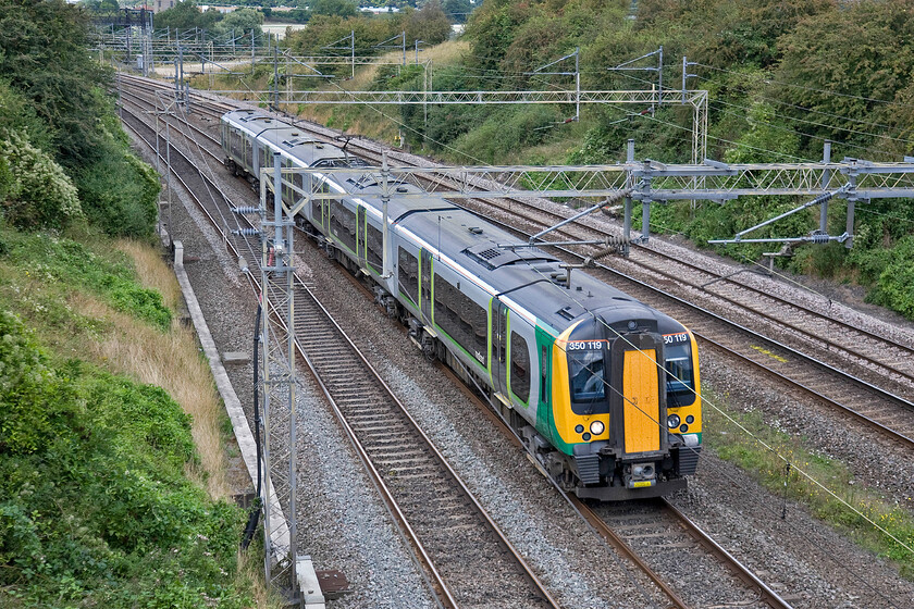 350119, LM 12.02 Crewe-London Euston (1U80), Victoria bridge 
 Avoiding all the problems in the Birmingham area by travelling via the Trent Valley route from Colwich Junction 350119 passes just south of Roade working the 12.02 Crewe to Euston service. 
 Keywords: 350119 12.02 Crewe-London Euston 1U80 Victoria bridge London Midland Desiro