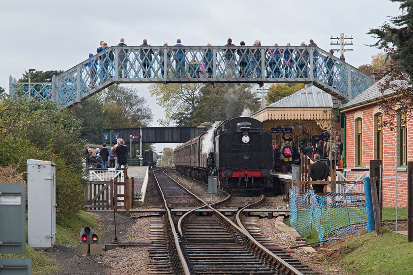 92203, 14.25 Holt-Sheringham, Sheringham station 
 92203 'Black Prince' arrives into a busy Sheringham station with the 14.25 from Holt. This picture shows the recently installed footbridge. This opened in June just before the start of the full summer season. Unusually for a heritage railway, the bridge was not acquired second-hand from elsewhere but was made to order in sections and installed Meccano style. The NNR is also installing a new footbridge at the other end of their line at Holt. 
 Keywords: 92203 14.25 Holt-Sheringham Sheringham station