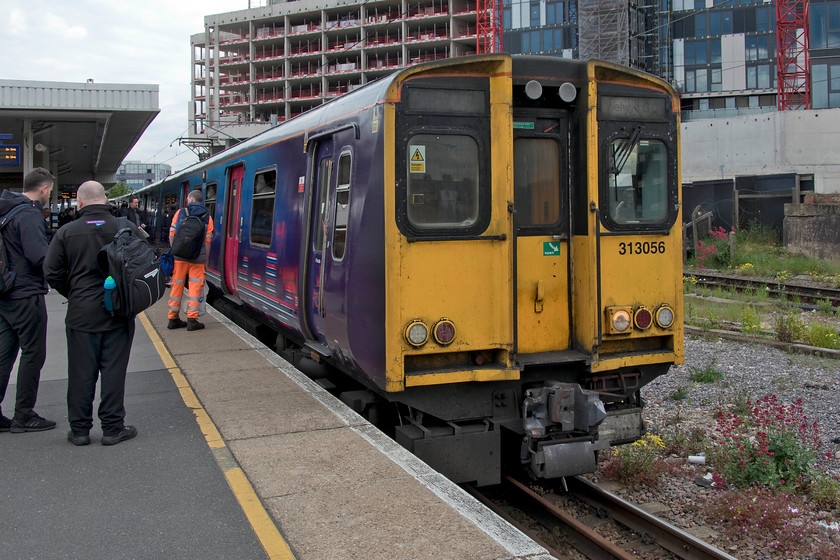 313056, 16.15 Moorgate-Welwyn Garden City (2V09, RT), Finsbury Park station 
 The 16.15 Moorgate to Welwyn Garden City stopper service has recently emerged from the depths of London to continue its journey to Welwyn. The 2V09 is formed of veteran units 313056 and out of sight at the back is 313041. There appeared to be a problem as the unit sat for some time in Finsbury Park station with a lot of standing about. However, it made up any delays as it arrived in Welwyn on-time. 
 Keywords: 313056 16.15 Moorgate-Welwyn Garden City 2V09 Finsbury Park station