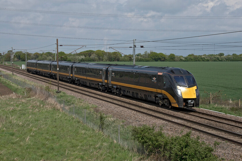 180103, GC 11.53 Sunderland-London King's Cross (1A65, 3L), Joan Croft Junction 
 The 11.53 Sunderland to London King's Cross Grand Central service approaches Joan Croft Junction worked by 180103. The photograph is taken from the western side of the new bridge embankment that was opened in 2014 following the closure of the nearby level crossing. Notice the steam being emitted from Drax power station in the background. Of South Yorkshire's 'big three' Drax was the largest having a capacity of 3960 MW burning a combination of biomass and petcoke (petroleum coke) delivered by rail. The other two power stations, Ferrybridge and Eggborough, have both been closed with the former in the process of being cleared. 
 Keywords: 180103 11.53 Sunderland-London King's Cross 1A65 Joan Croft Junction Grand Central