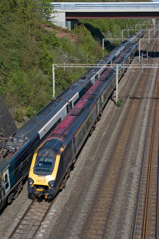 221112, VT 09.20 Chester-London Euston (1A19, 12L) & 390153, VT 10.16 London Euston-Edinburgh Waverley (9S60, 21L), Roade cutting 
 A passing of Avanti services in Roade cutting. To the left one of their Pendolinos heads northwards working the 9S60 10.16 Euston to Edinburgh worked by 390153. Whilst to the right is an endangered species in the form of Voyager 221112 heads south working the 09.20 Chester to Euston service. 
 Keywords: 221112 09.20 Chester-London Euston 1A19 390153 10.16 London Euston-Edinburgh Waverley 9S60 Roade cutting Avanti west Coast AWC Voyager Pandolino