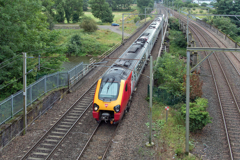 Class 221, VT 10.54 Preston-Glasgow Central (1Z47), Etterby NY388571 
 Having arrived at Carlise in order to get to DRS's Kingmoor headquarters, we took a pleasant walk from the station rather than taking their bus shuttle service. Just close to the entrance to the Kingmoor depot in the village of Etterby just north of Carlisle, a Virgin class 221 crosses the River Eden working the 1Z47 10.54 Preston to Glasgow Central. This unusual working is not, in fact, an enthusiast's special (221s have not quite reached that status just yet!) but a special working put on due to the closure of Weaver Junction for re-building and the consequential closure of the WCML in that area. As well as some services going via Manchester, a series of shuttles operated between Preston and Scotland in an attempt to maintain some semblance of normality for customers. 
 Keywords: Class 221 10.54 Preston-Glasgow Central 1Z47 Etterby NY388571