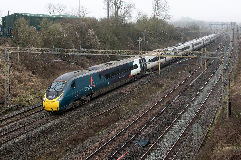 390006, VT 10.15 Manchester Piccadilly-London Euston (1A22, 4E), Victoria bridge 
 390006 'Rethink Mental Illness' has just fifty-eight miles to go to complete its journey as the 1A22 10.15 Manchester Piccadilly to Euston Avanti West Coast service. Despite having hundreds of photographs of Pendolinos I have precious few of 390006 with this being the first time I have caught it in its Avanti livery. The train is seen passing Victoria bridge just south of Roade. 
 Keywords: 390006 10.15 Manchester Piccadilly-London Euston 1A22 Victoria bridge Avanti West Coast Pendolino Rethink Mental Illness