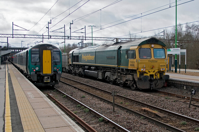 350231, LN 10.06 Birmingham New Street-London Euston (1Y30, RT) & 66506, 09.07 Willesden Eurotunnel-New Bilton (6R93, RT), Northampton station 
 London Northwestern's 350231 is seen waiting to leave with the 10.06 Birmingham New Street to Euston service. My wife and I travelled south from Northampton to Euston on this service seen at Northampton's platform one as the 6R93 09.07 Willesden Eurotunnel to Rugby New Bilton passes lead by Freightliner's 66506 'Crewe Regeneration'. This loaded freight is taking yet more mined waste from HS2 works in the London area to be emptied into a huge water-filled former quarry to the north of Rugby. Evidence of this work can be seen on the latest 2023 updated image from Google Earth just search 'Lawford Bridge Close, Rugby'. 
 Keywords: 350231 10.06 Birmingham New Street-London Euston 1Y30 66506 09.07 Willesden Eurotunnel-New Bilton 6R93 Northampton station Freightliner London Northwestern Desiro Crewe Regeneration