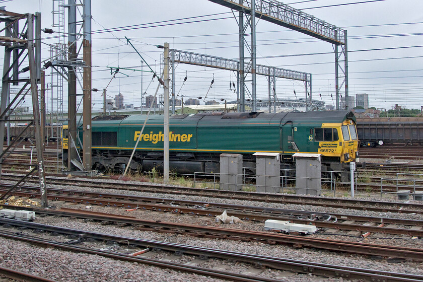 66572, stabled, Wembley Yard 
 Freightliner's 66572 stands stabled in Wembley Yard awaiting its next turn of duty. Amongst the tower blocks of north London in the background Wembley stadium is also in view. 
 Keywords: 66572 stabled Wembley Yard