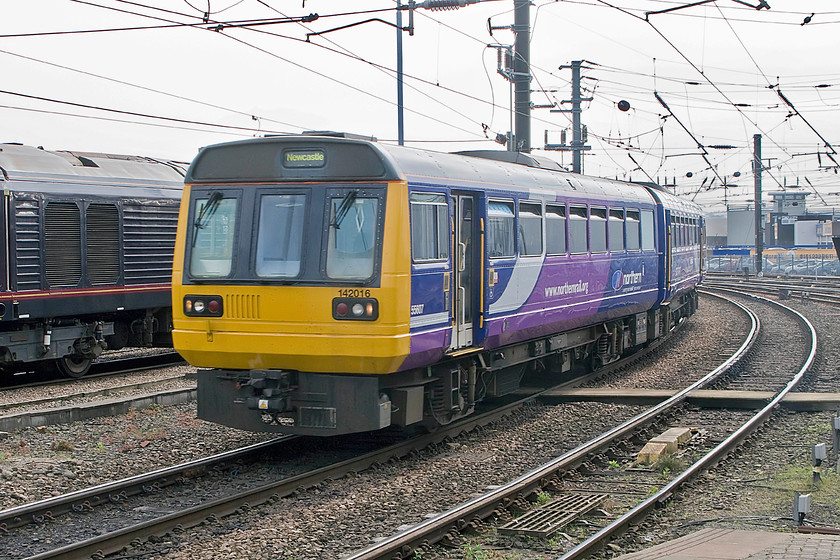 67006, stabled thunderbird & 142016, 15.31 Metrocentre-Newcastle (2W49), Newcastle station 
 You can almost hear the wheel flanges of 142016 squealing as they make contact with the check rail as it arrives into Newcastle station! The Pacer is arriving at the station with the 15.31 shuttle service from Metrocentre and is seen passing the stabled Thunderbird in the form of 67006 'Royal Sovereign'. 
 Keywords: 67006 thunderbird 142016 15.31 Metrocentre-Newcastle 2W49 Newcastle station Northern Trains Pacer