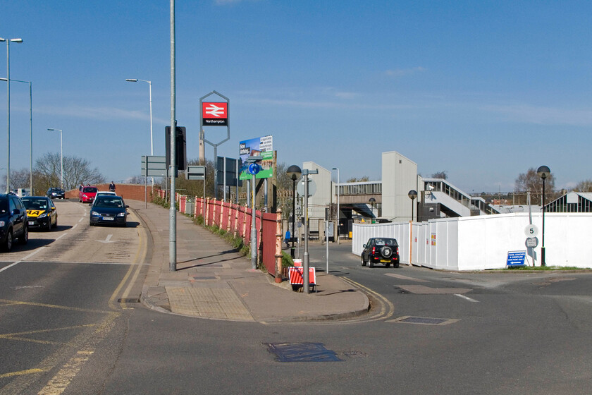 Northampton station entrance & archaeological dig site for the castle 
 The re-development of Northampton's station should have been at a more advanced stage by now but for the discovery of archaeological remains under the front car park. The area being excavated and catalogued is presently cordoned off behind the screens to the right whilst the station struggles to function with its front car park being out of use. This photograph is taken from the main entrance with Westbridge Road to the left. Notice the cast iron railings in the centre that survived the 1965-66 redevelopment being installed at a much earlier time. 
 Keywords: Northampton station entrance & archaeological dig site for the castle