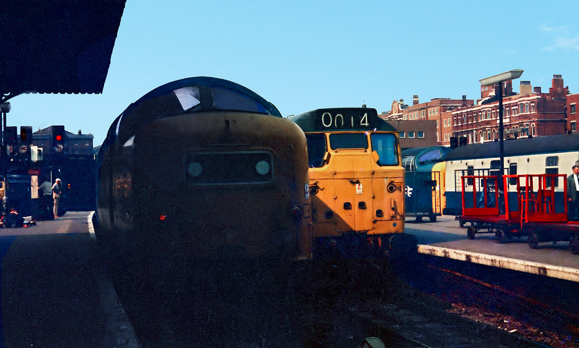 Class 55s & class 31, unidentified workings, London Kings Cross station 
 At the platform end at King's Cross reveals a busy scene. There are two Deltics in the view, unfortunately neither are identified; my notes have long-gone! The station pilot class 31 is busying itself and, at the fulling point a class 47 can just be seen. Looking at the angle of the sun this picture would have been taken in the late afternoon. I apologise for the excess shadow on the Deltic in the foreground, the camera and film was unable to cope with the excess contrasts and Photoshop reached its limits! 
 Keywords: Class 55 Deltic class 31 London Kings Cross station