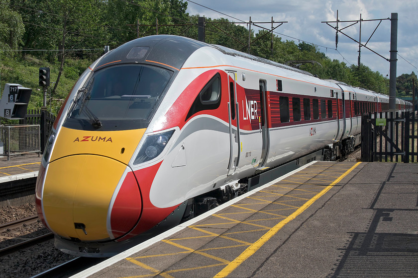 800110, GR 14.33 London King`s-Cross-Leeds (1D18, 2L), Oakleigh Park station 
 It has to be admitted that the LNER livery applied to the Azumas is so much better than the drab green of Great Western's IET equivalents. 800110 sweeps through Oakleigh Park some eight miles into its journey forming the 14.33 King's Cross to Leeds. Again, the camera's flip-out screen has been utilised with me holding it over the railings to secure this photograph. It's lovely to see the front ends of these trains looking so pristine, but after a summer of hitting insect up and down the ECML I wonder if they will become a little work-stained? 
 Keywords: 800110 14.33 London King`s-Cross-Leeds 1D18 Oakleigh Park station