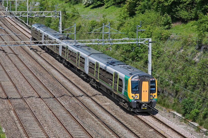 350107, LM 09.30 Crewe-London Euston, Hyde Road bridge 
 During the week Crewe services operated by London Midland take the fast lines thus avoiding Northampton but not at the weekends. 350107 passes through Roade cutting working the 09.30 Crewe to Euston service. 
 Keywords: 350107 09.30 Crewe-London Euston Hyde Road bridge London Midland Desiro