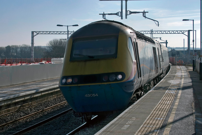 43054, EM 11.33 London St. Pancras-Nottingham (1D28, 1E), Wellingborough station 
 Taken somewhat into the light but an HST is an HST and this particular example (and all of the EMR examples for that matter) is operating on borrowed time about to be replaced by ex LNER sets. 43054 leads the 11.33 St. Pancras to Nottingham through Wellingborough station with lots more evidence behind it of the electrification programme and the extending of the existing platforms with the reinstatement of the old platform five to become the new platform four. 
 Keywords: 43054 11.33 London St. Pancras-Nottingham 1D28 Wellingborough station HST East Midlands Railway EMR