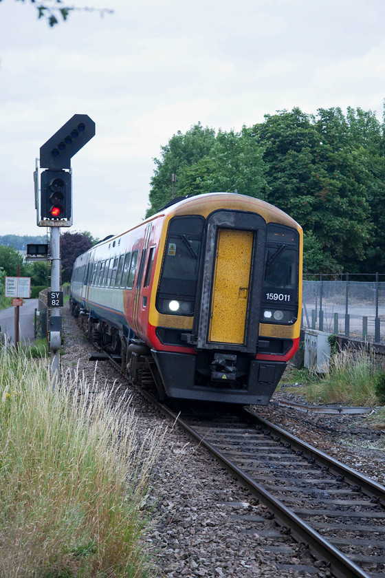 159011, SW 16.50 London Waterloo-Castle Cary (1L51, 4L), Tisbury station 
 159011 arrives at Tisbury station working the 16.50 Waterloo to Castle Cary. No, I did misread the timetable, this working was to reverse at Yeovil Junction and head to Castle Cary in connection with revellers at the Glastonbury Festival that was mid-way through. 
 Keywords: 159011 1L51 Tisbury station